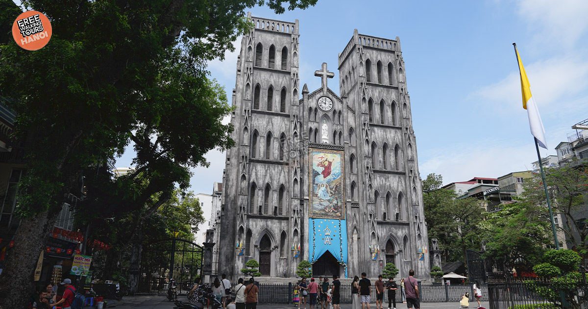Gothic-style St. Joseph’s Cathedral surrounded by Vietnamese street vendors 